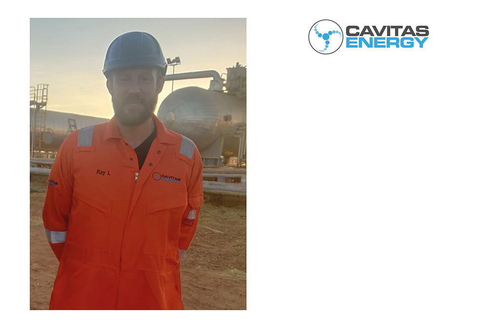 an engineer wearing a hard hat and an orange cavitas energy uniform